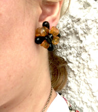 Load image into Gallery viewer, Big Plastic Clip on Earrings ROCHELLE Chrysanthemum Style Earrings in Golden Orange and Black